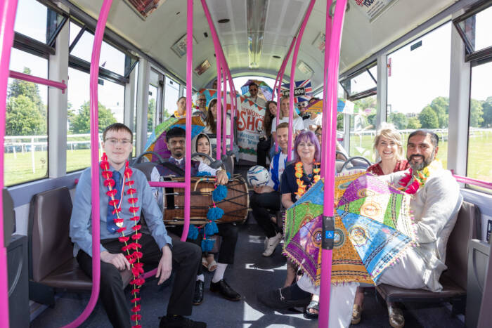 People in different costumes on a bus