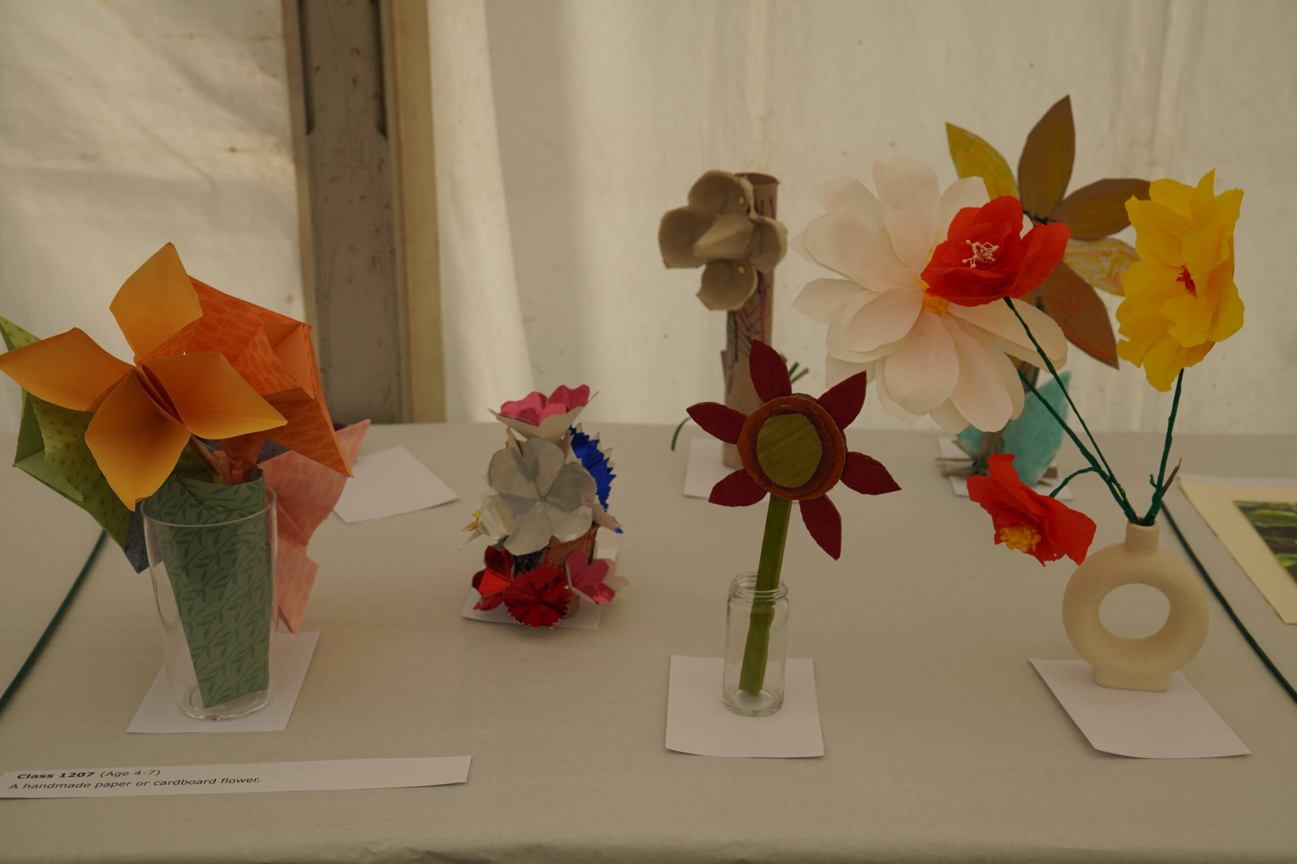 A display of handmade paper flowers, made by children