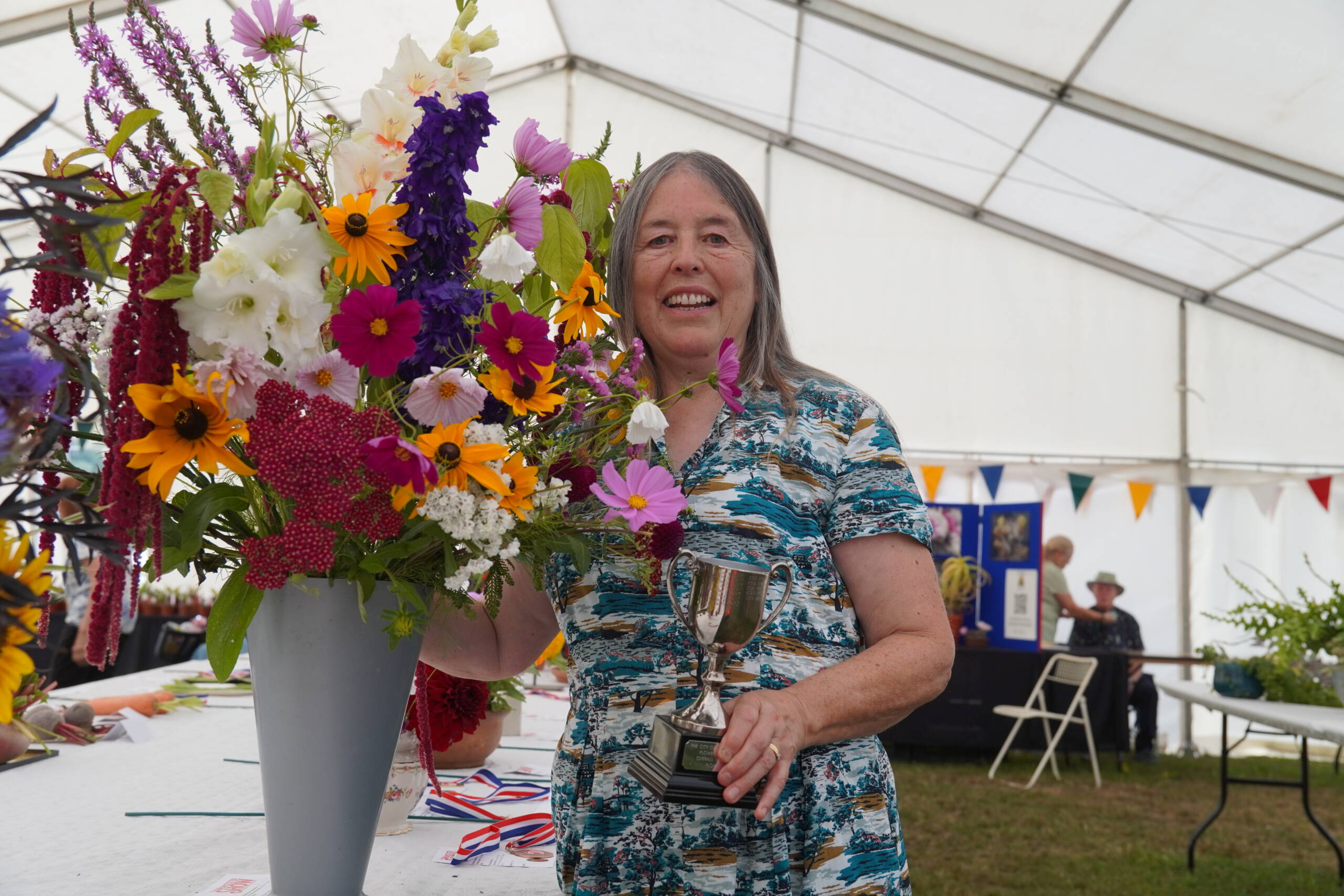 Floral Section winner with a vase of her winning flowers