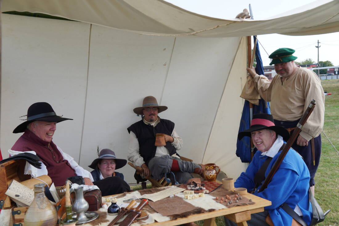 Civil war reenactors relaxing around a table